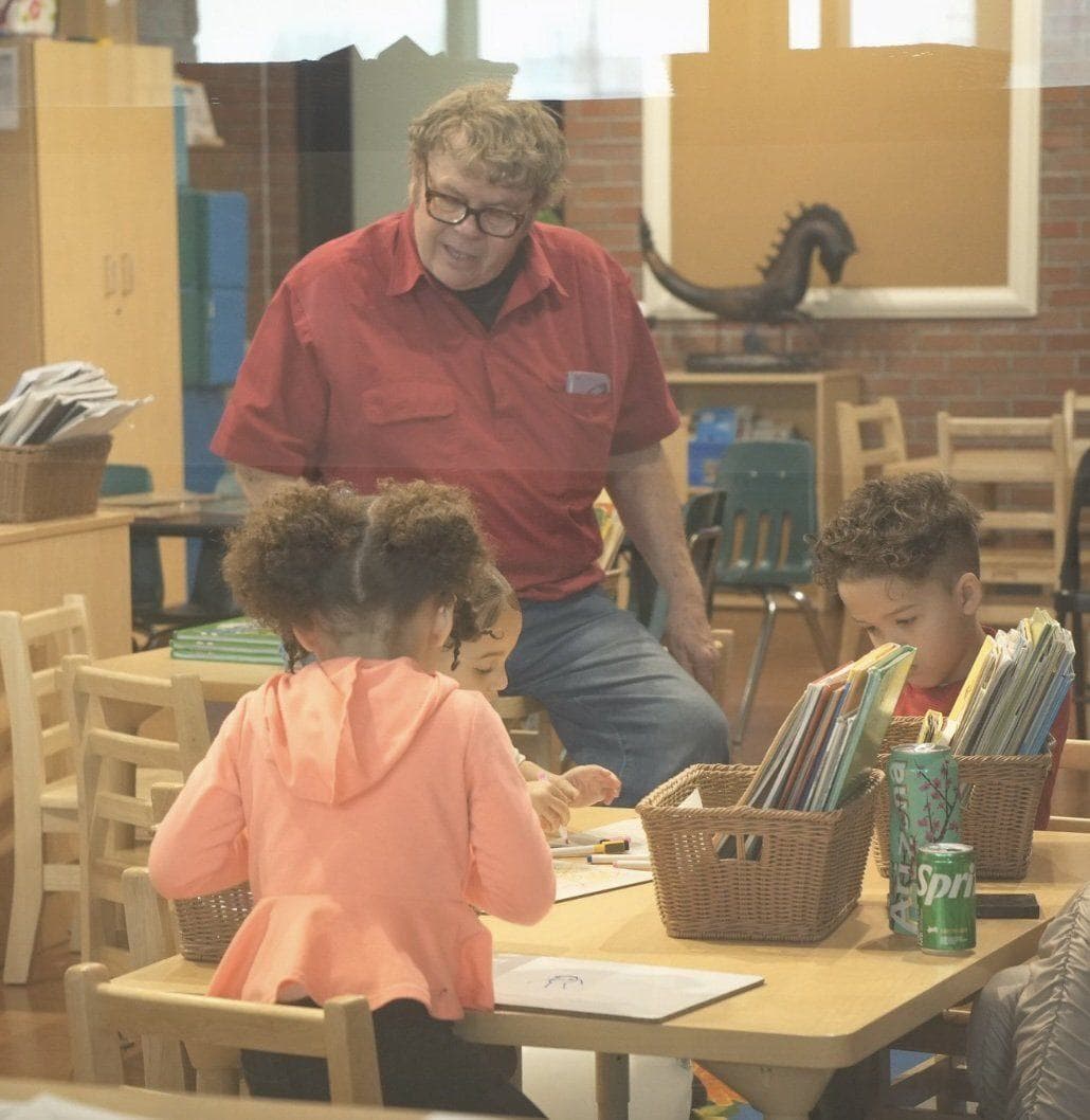 A teacher reading with a child