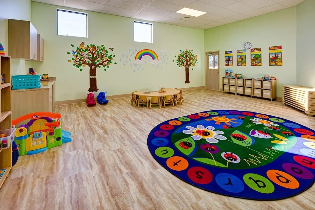 A bright preschool classroom with painted trees at the Smoky Hill campus