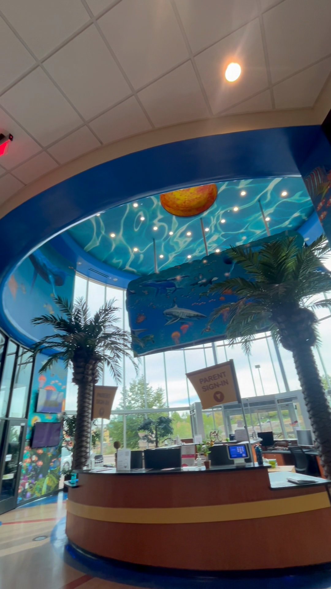 The Novastar lobby under its ocean-mural ceiling